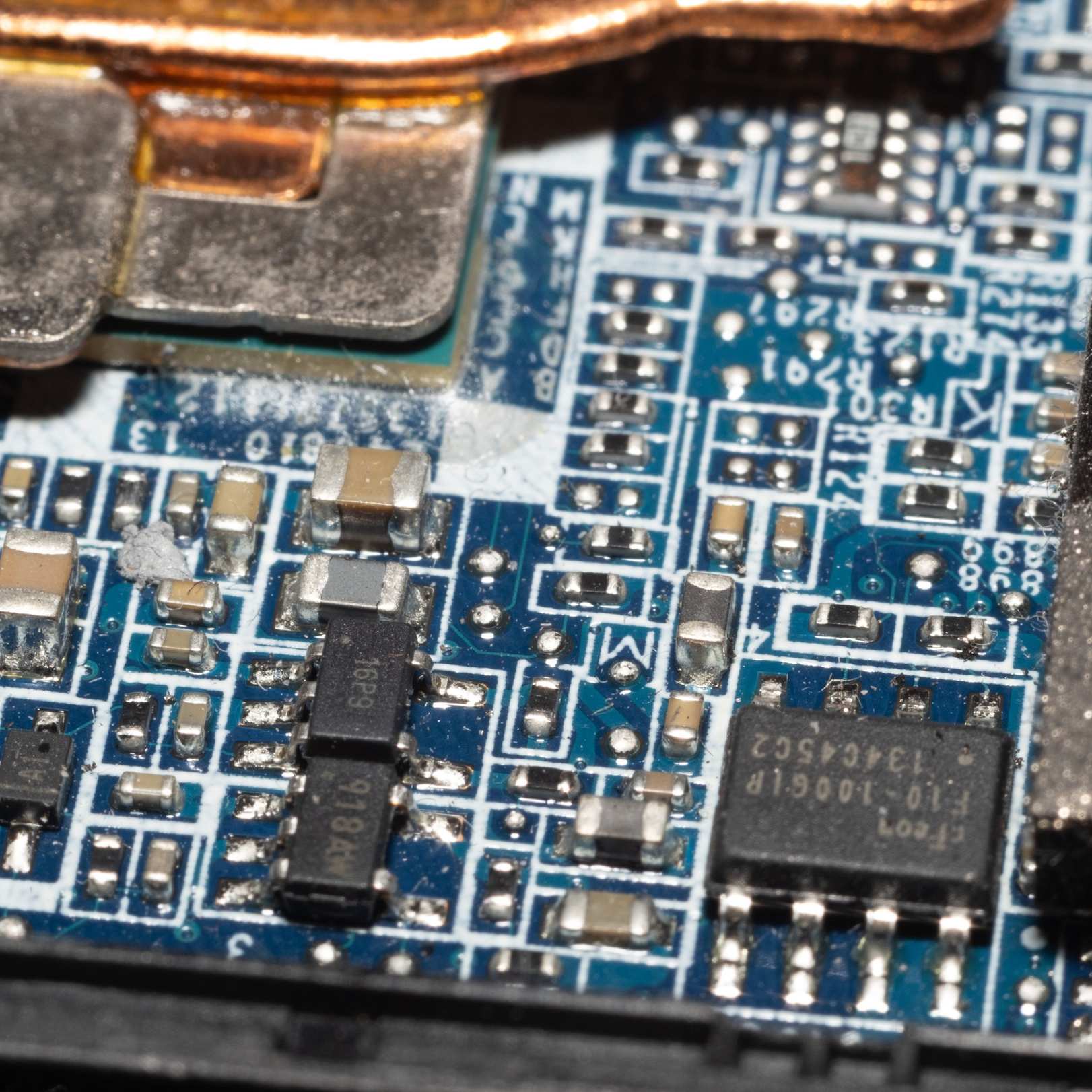 Circuit board and small tools on a work surface, macro shot of a circuit board with microchips